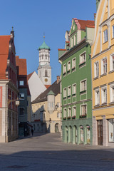 Fototapeta na wymiar colored buildings on a Memmingen square, blue and clear sky