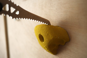 Dry Tooling ice tool hanging from a wooden board and rest on a resin climbing holds