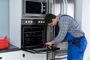 Repairman Repairing Oven