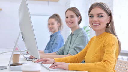 Beautiful Creative Women working and Smiling at the Camera