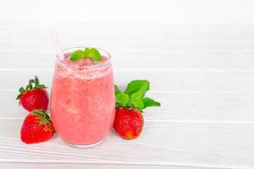 Strawberry yogurt fruit juice smoothie pink colorful fruit juice milkshake blend beverage healthy high protein the taste yummy In glass drink episode morning on white wood background.