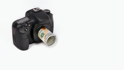 Photo camera and money isolated on white background
