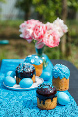 Table served for Easter lunch. Beautiful decor and easter cakes in light blue tones. Vertical frame