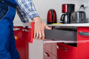 Male Carpenter Installing Drawer