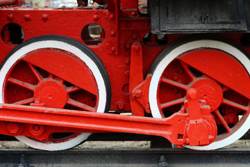 Metal wheels of a steam locomotive on a railway, background