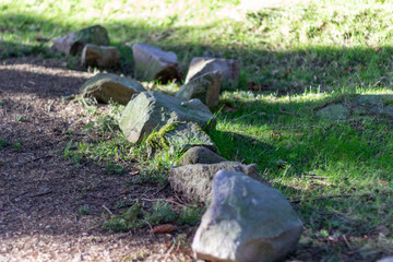 Line of stones next to the path in Tyrebagger Woods