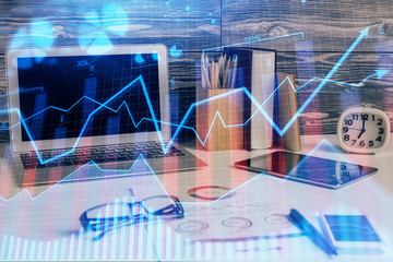 Multi exposure of chart and financial info and work space with computer background. Concept of...