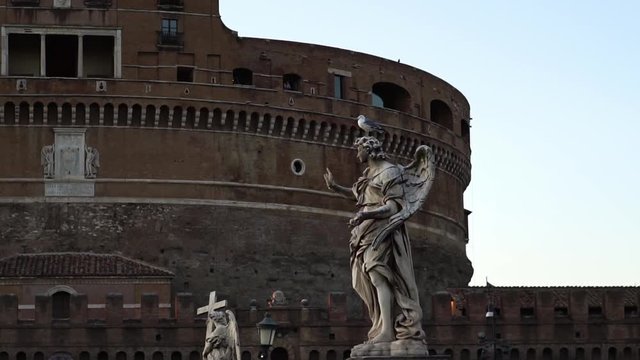 Religious statue on Sant Angelo Bridge, Vatican, Rome, Italy. Historic landmark. Castle Sant Angelo. Summer tourism vacation & family travel destination in Europe. 