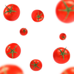 Red tomatoes with cuttings flying isolated on a white background