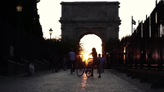 Sunset light in Roman Forum, Arch next to Colosseum in Rome, Italy. Historic landmark. Tourism vacation & family travel destination in Europe.