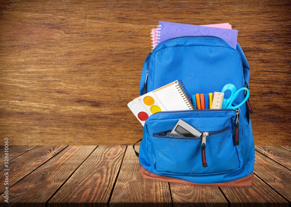 Canvas Prints Classic school backpack with colorful school supplies and books on desk.