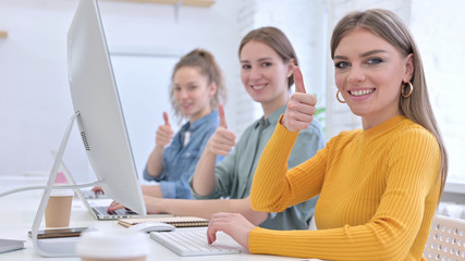 Ambitious Young Designer Team showing Thumbs Up