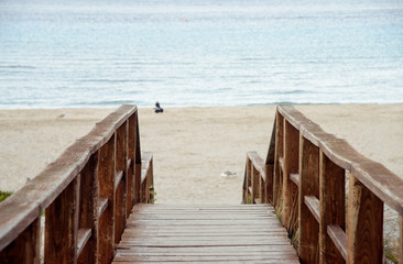 Fototapeta premium Wooden stairs down to sand beach
