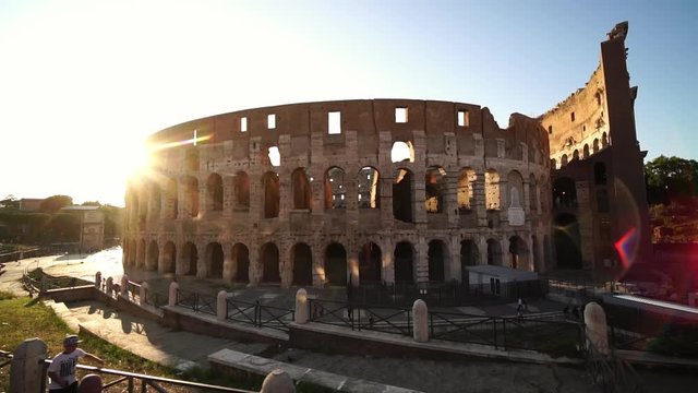 Low angle drone shot. Colosseum in Rome, Italy. Famous Roman Coliseum. Popular travel destination. Tourism attraction landmark in Europe. 
