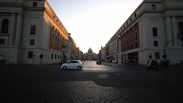 Cars in front of Saint Peter’s Basilica in Vatican city, Rome, Italy. Summer tourism landmark & family travel destination in Europe. Religious monument. 