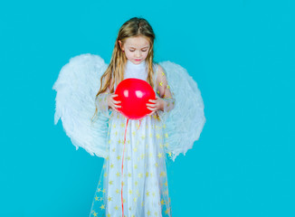 Kids Valentines Day. Cute child girl posing with angel wings. Child angel with a beautiful wings....