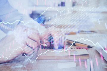 Multi exposure closeup hands with stock market forex graph.