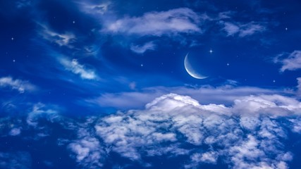 Moon in bright clouds of sunset sun . New moon , moon in the blue sky new moon in the clouds  © yaalan