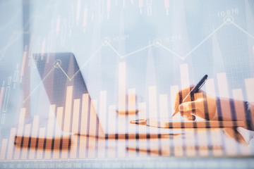 Multi exposure of forex chart with man working on computer on background. Concept of market analysis.