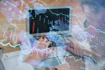 Multi exposure of market chart with man working on computer on background. Concept of financial analysis.
