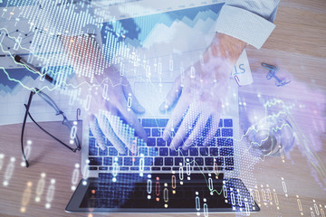 Double exposure of market chart with man working on computer on background. Concept of financial analysis.