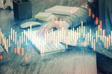 Multi exposure of financial graph with man works in office on background. Concept of analysis.