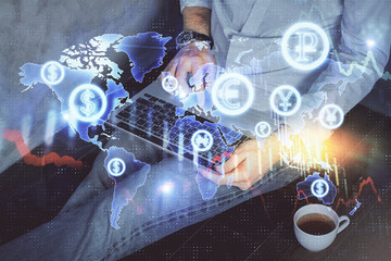 Forex graph with businessman working on computer in office on background. Concept of analysis. Double exposure.