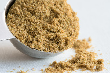 Ground Cumin Spilled from a Teaspoon