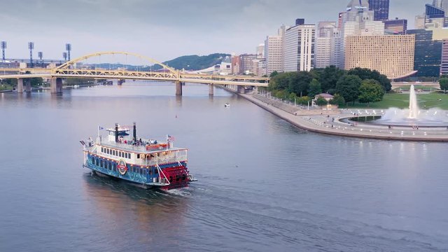 Aerial: Steamship ferry boat on the Allegheny River river at sunset. Pittsburgh, Pennsylvania, USA. 16 September 2019