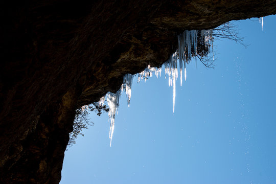 Icicles Hanging Off The Edge Of A Cliff