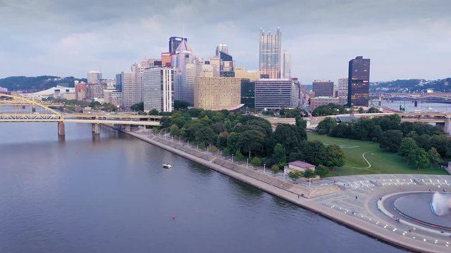 Aerial: Ferry boat on the Allegheny River river at sunset and downtown Pittsburgh, Pennsylvania, USA