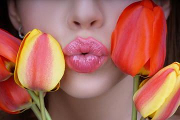 Woman with tulips kiss. Sensual lips. Kissing. 8 march women's day.