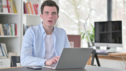 Fototapeta premium Shocked Young Man Working on Laptop