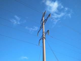 tower pole with wires high voltage power transmission against the sky electricity