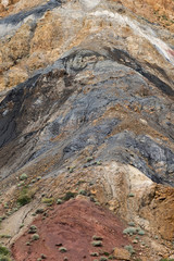 Colored hills, stripes of different colors on slope of canyon. Dry land due to lack of water. Drought in desert. Soil erosion