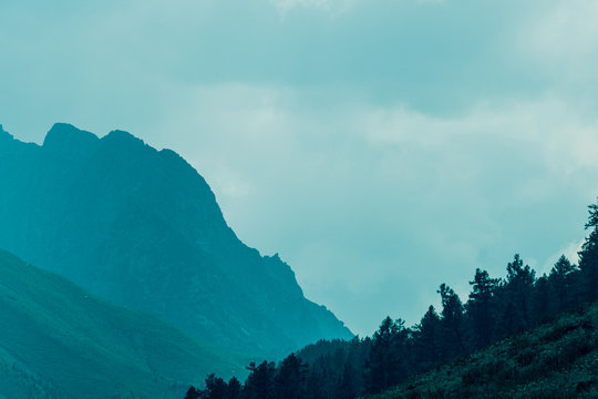 high cliffs in blue haze, silhouette of mountain range in fog, meditation and relaxation in nature