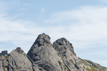 rock ridge under blue cloudy sky, mountain tourism, tourist area for relaxation
