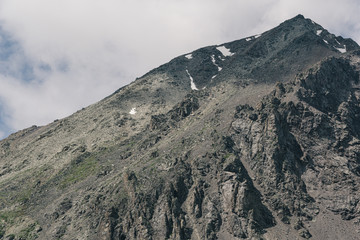 rock cliff against sky. Travel in mountains, stone wall for mountaineering