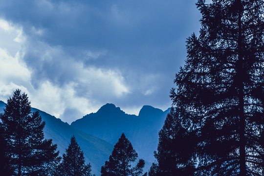 high cliffs in blue haze, silhouette of mountain range in fog, meditation and relaxation in nature