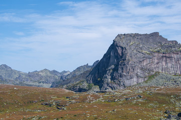 rock ridge under blue cloudy sky, mountain tourism, tourist area for relaxation
