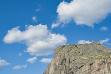 peak under blue sky with clouds, preparation for climbing rock ridge, journey in mountain valley