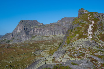 mountain trail to rock top and cliff, hiking and mountaineering on mountain ridge, symbolizes path to success, perseverance in achieving goals