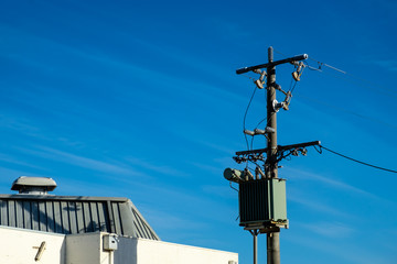 A high electric pole with transformer and transmission line on an island
