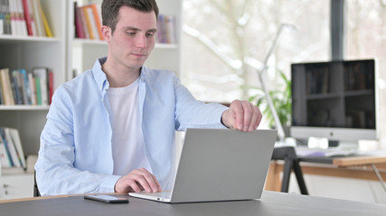 Young Man Opening Laptop for Work