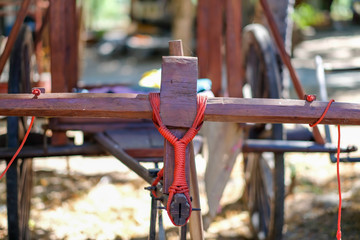 Red rope tied to the wooden wagon head