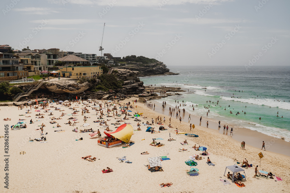 Wall mural tamarama, new south wales - january 20th, 2020: people enjoying the summer weekend weather at tamara