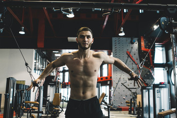 Fototapeta na wymiar handsome bearded guy training in a gym