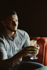guy with a cocktail in a bar
