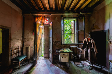 Wide angle view of the interior of the kitchen of an old abandoned Italian country house