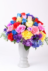 Colorful flower arrangement centerpiece in white ceramic vase